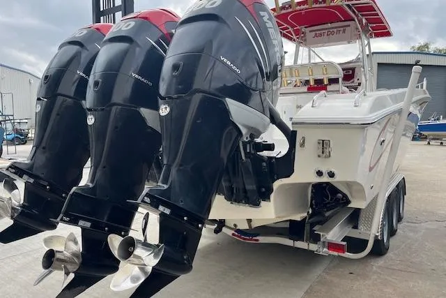 Slide: The Image of Triple 300 horsepower outboard engines on a 2001 Fountain 38 Center Console boat. - 5