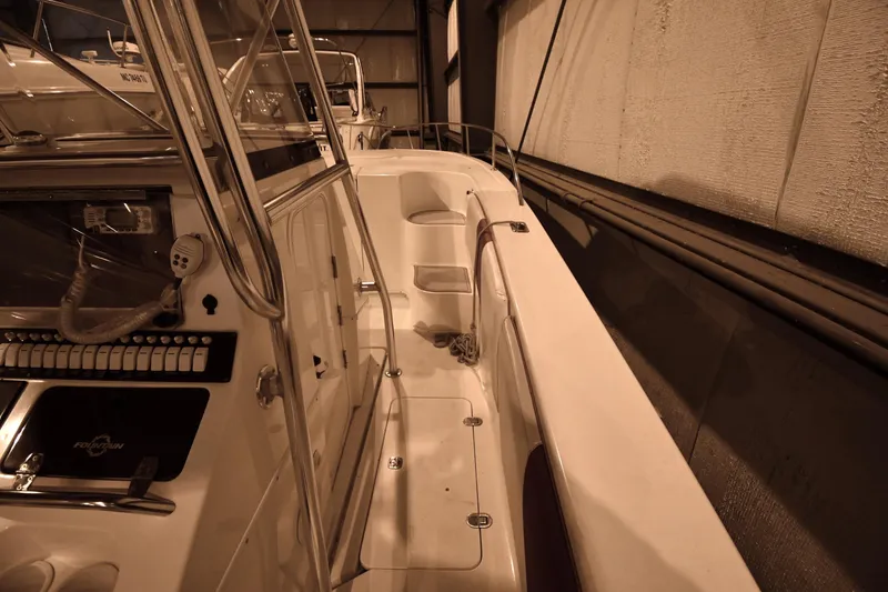 Slide: The Image of 2001 Fountain 38 Center Console boat interior with control panel and seating. - 52