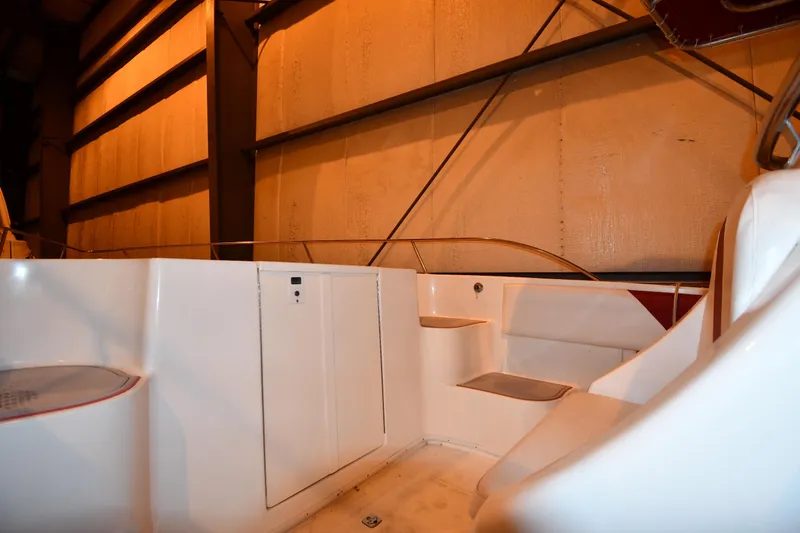Slide: The Image of 2001 Fountain 38 Center Console boat interior with seating and storage in a dimly lit space. - 53