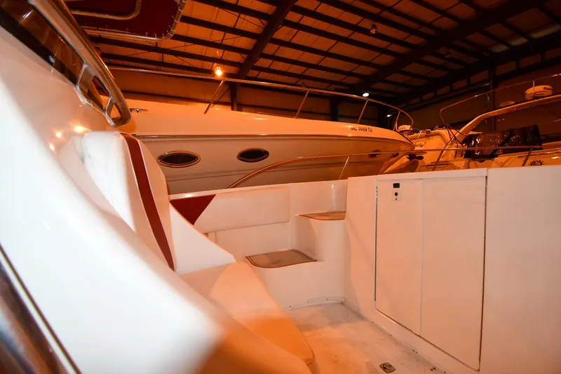 Slide: The Image of 2001 Fountain 38 Center Console boat interior in a dimly lit storage facility. - 54