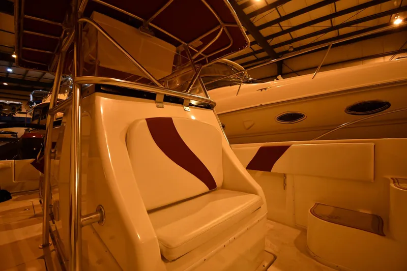 Slide: The Image of 2001 Fountain 38 Center Console boat interior with cushioned seating in a showroom. - 55