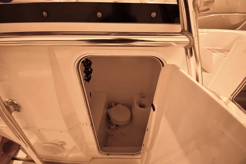 Slide: The Image of 2001 Fountain 38 Center Console boat interior with open storage compartment. - 56