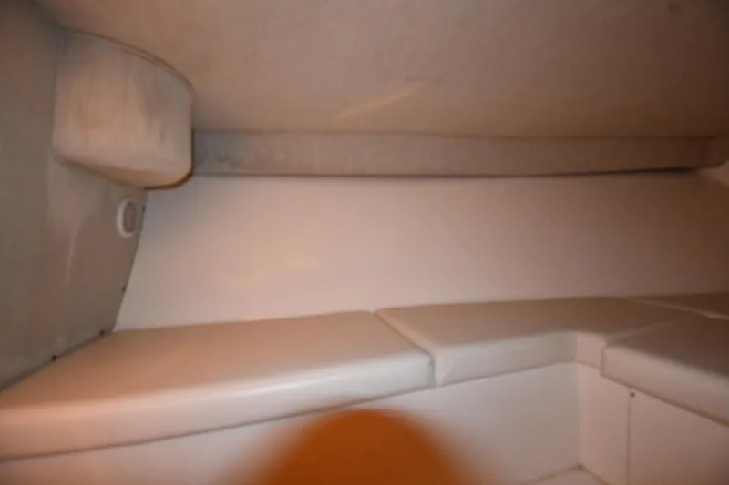 Slide: The Image of Interior cabin of a 2001 Fountain 38 Center Console boat, featuring cushioned seating. - 60