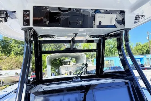 Slide: The Image of 2026 Tidewater 302 CC Adventure boat console with Garmin electronics and sleek black frame. - 12