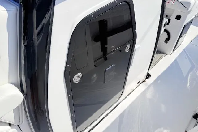 Slide: The Image of 2026 Tidewater 302 CC Adventure boat, sleek black and white exterior detail. - 16