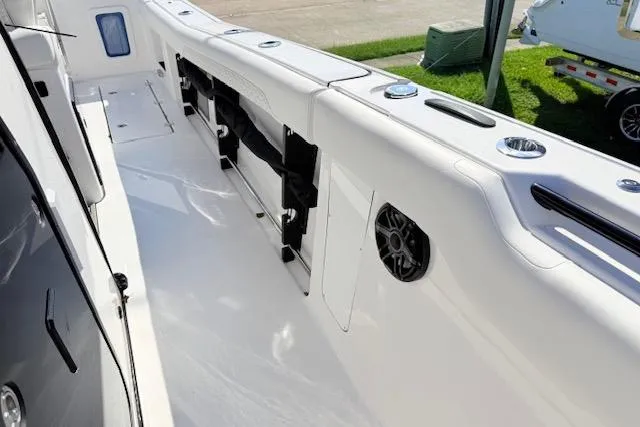 Slide: The Image of 2026 Tidewater 302 CC Adventure boat interior with sleek white deck and built-in speaker. - 17