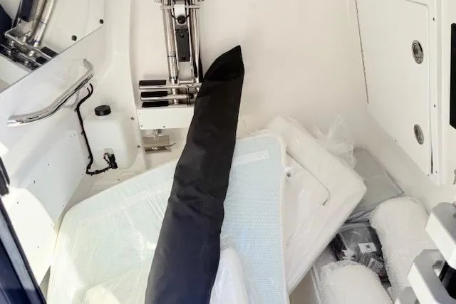 Slide: The Image of 2026 Tidewater 302 CC Adventure boat interior with equipment and storage area. - 18