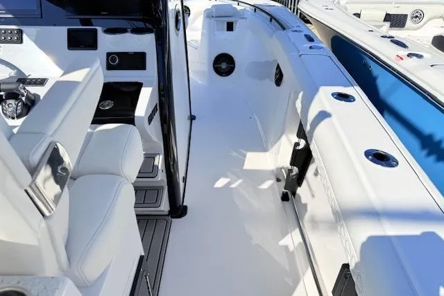 Slide: The Image of 2026 Tidewater 302 CC Adventure boat interior with sleek white seating and modern controls. - 19