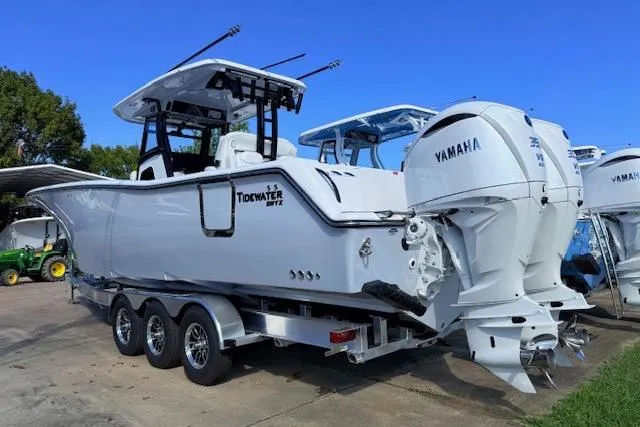 Slide: The Image of 2026 Tidewater 302 CC Adventure boat with Yamaha engines on a trailer. - 2