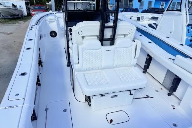 Slide: The Image of 2026 Tidewater 302 CC Adventure boat with white seating and spacious deck layout. - 4