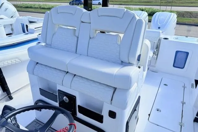 Slide: The Image of 2026 Tidewater 302 CC Adventure boat with luxurious white seating and modern helm design. - 8