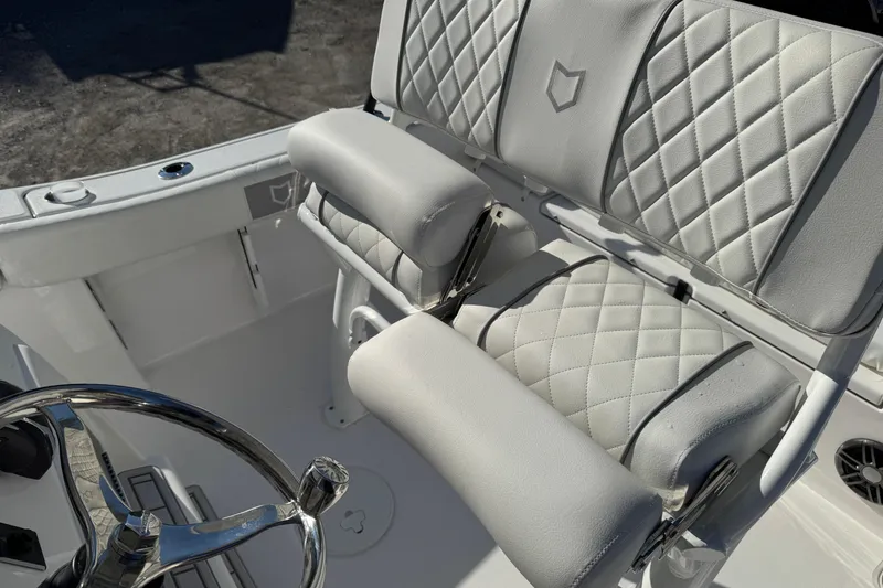 Slide: The Image of 2026 Sea Fox 228 Commander boat interior with quilted seating and steering wheel. - 16