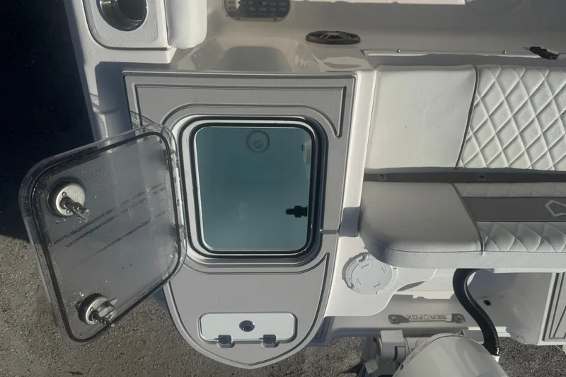 Slide: The Image of 2026 Sea Fox 228 Commander boat interior with open storage compartment and cushioned seating. - 19