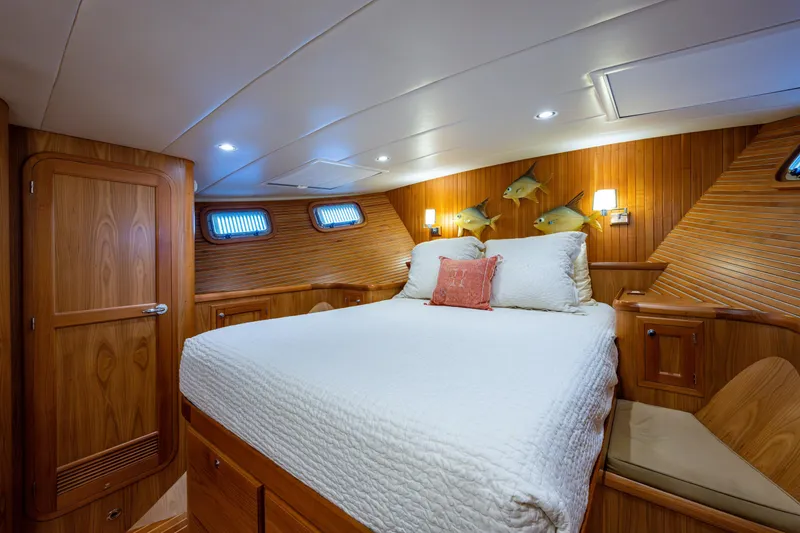 Slide: The Image of Master stateroom queen-size berth. There are large stainless steel opening ports port and starboard - 32