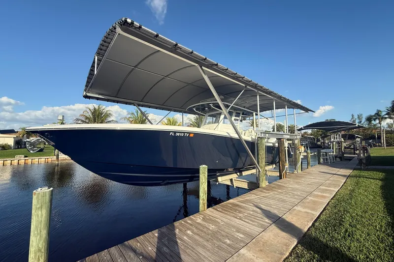 The Image of 2024 Invincible 39 Open Fisherman boat docked under canopy on sunny day. - 0