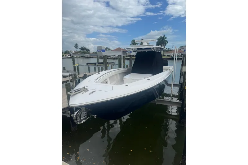 The Image of 2024 Invincible 39 Open Fisherman boat docked by waterfront homes. - 1