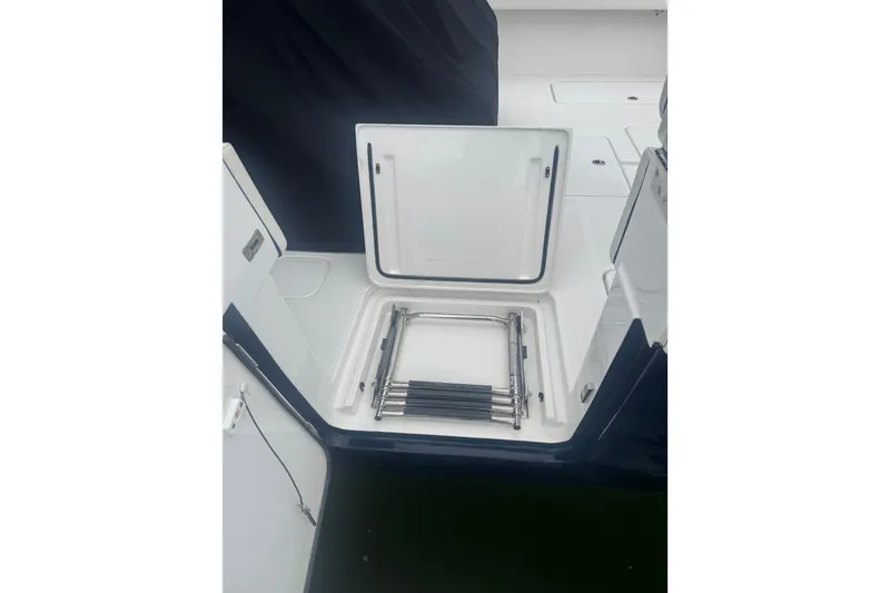 Slide: The Image of 2024 Invincible 39 Open Fisherman boat storage compartment with ladder. - 14