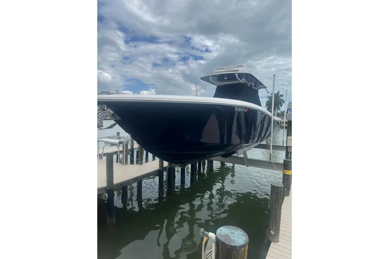 Slide: The Image of 2024 Invincible 39 Open Fisherman boat docked, showcasing sleek design and modern features. - 17