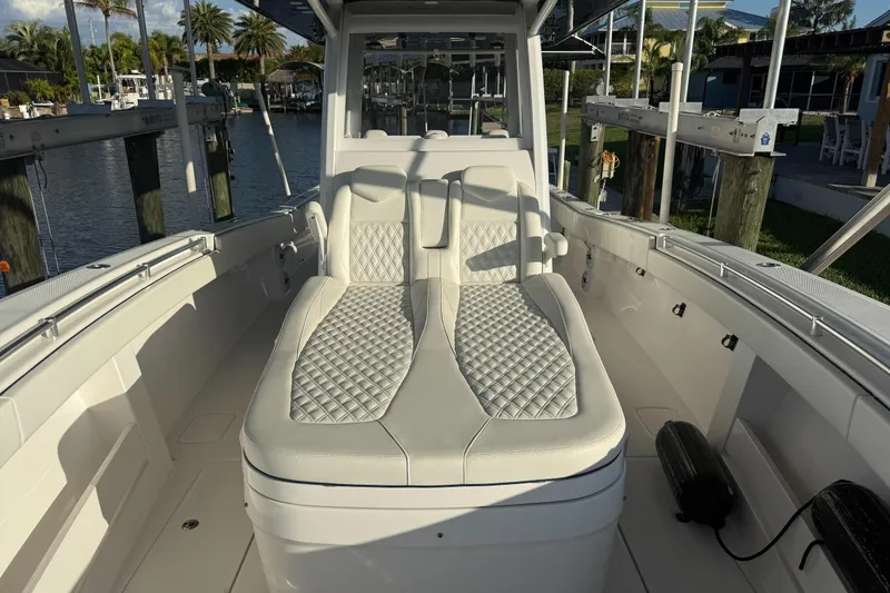 Slide: The Image of 2024 Invincible 39 Open Fisherman boat interior with luxurious seating and waterfront view. - 20