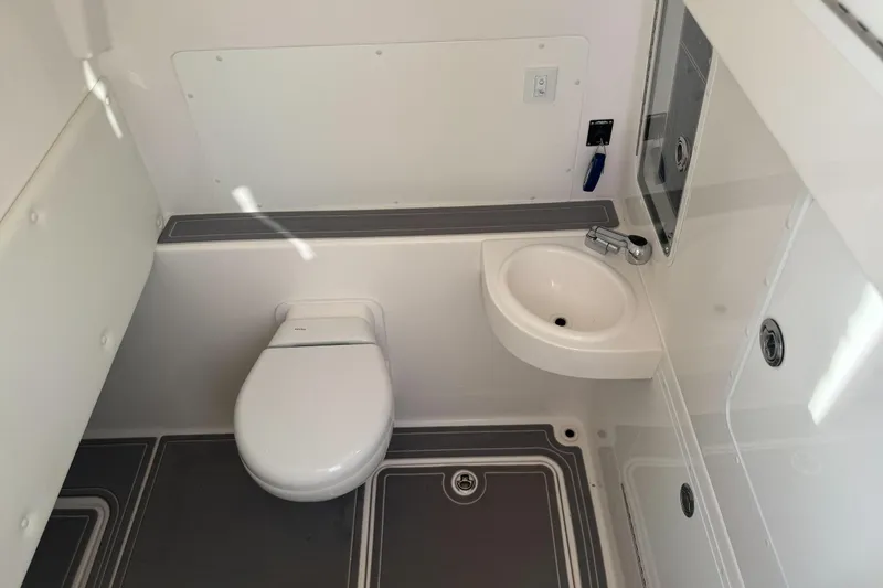 Slide: The Image of 2024 Invincible 39 Open Fisherman boat bathroom with toilet and sink. - 25