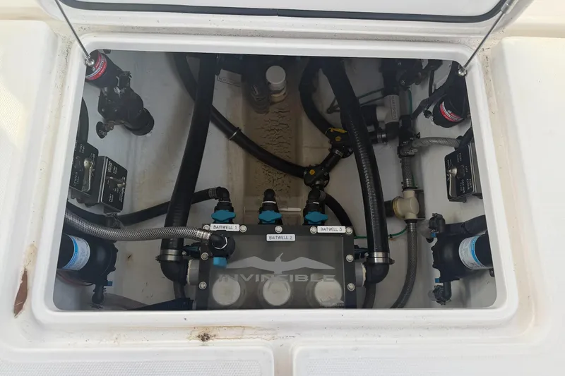 Slide: The Image of 2024 Invincible 39 Open Fisherman boat plumbing system with labeled baitwell connections. - 31