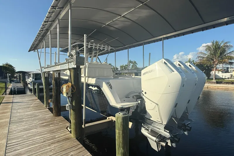 Slide: The Image of 2024 Invincible 39 Open Fisherman boat docked with triple Mercury engines. - 33