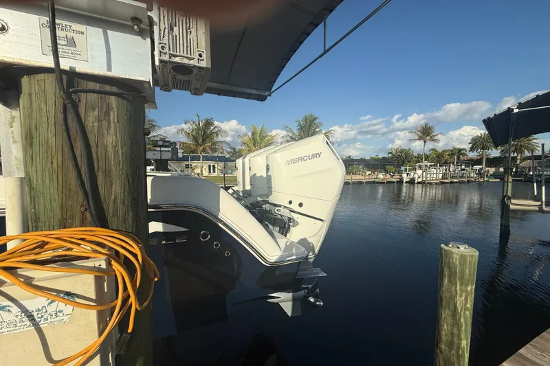 Slide: The Image of 2024 Invincible 39 Open Fisherman boat docked with Mercury engine, sunny marina view. - 37