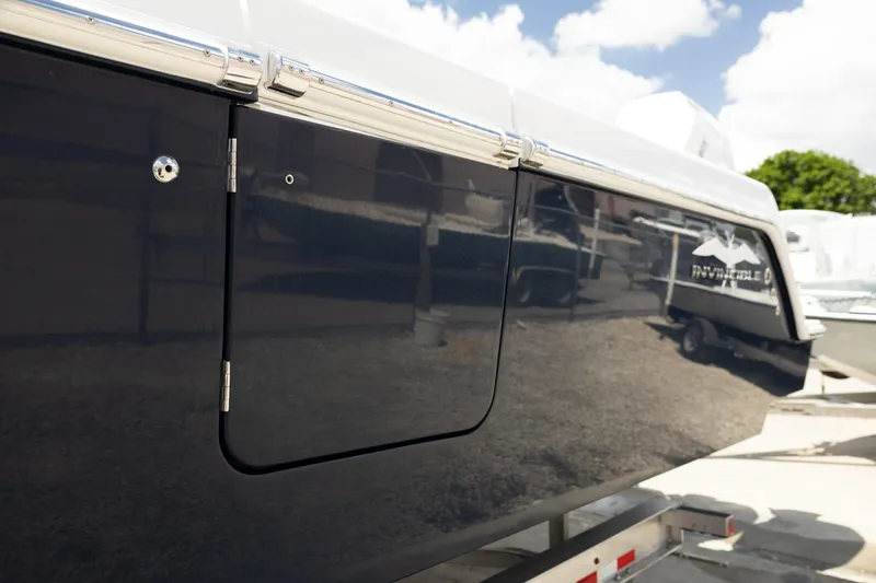 Slide: The Image of 2024 Invincible 39 Open Fisherman boat side view with sleek black finish. - 39