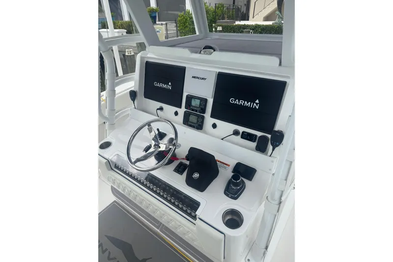 Slide: The Image of 2024 Invincible 39 Open Fisherman helm with Garmin displays and steering wheel. - 4
