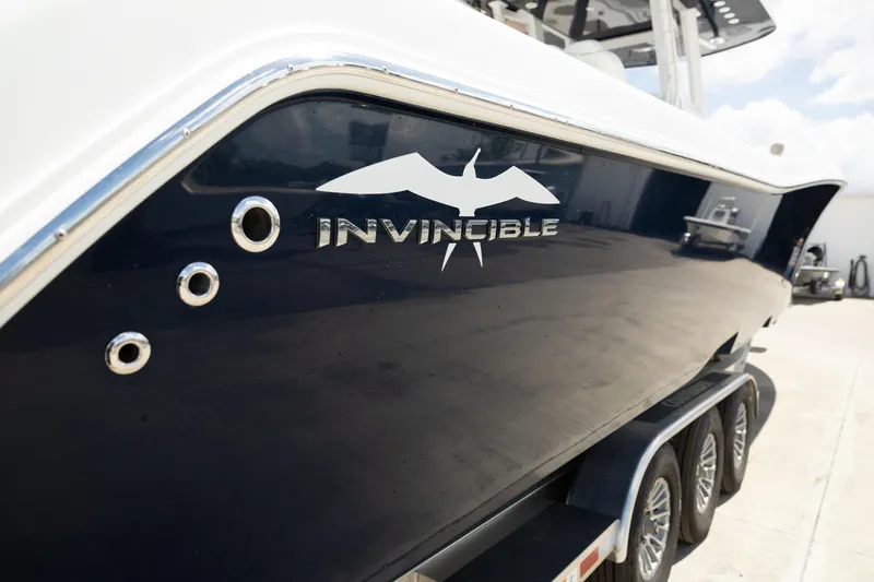 Slide: The Image of 2024 Invincible 39 Open Fisherman boat, sleek design with logo, on trailer. - 41