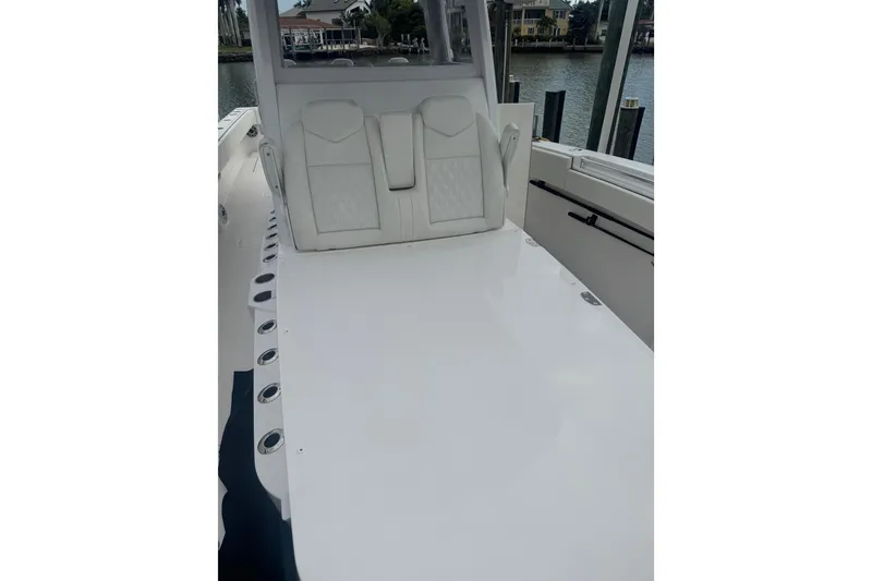 Slide: The Image of 2024 Invincible 39 Open Fisherman boat interior with white seating and rod holders. - 6