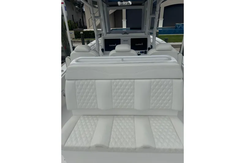 Slide: The Image of 2024 Invincible 39 Open Fisherman boat interior with white quilted seating. - 8