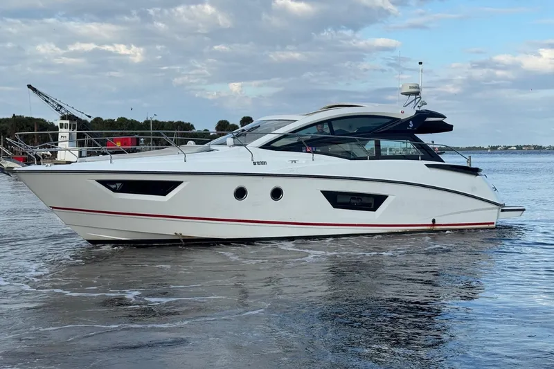 The Image of 2019 Beneteau Gran Turismo 40 yacht cruising on calm waters under a cloudy sky. - 0