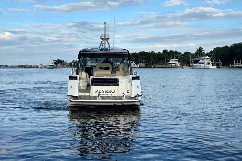 Slide: The Image of 2019 Beneteau Gran Turismo 40 yacht on calm water, rear view. - 11