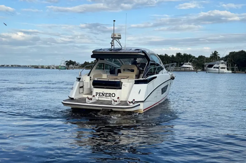 Slide: The Image of 2019 Beneteau Gran Turismo 40 yacht cruising on a calm waterway. - 13