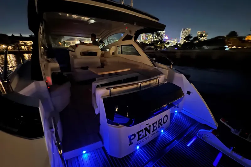 Slide: The Image of 2019 Beneteau Gran Turismo 40 yacht at night, illuminated with blue lights. - 15