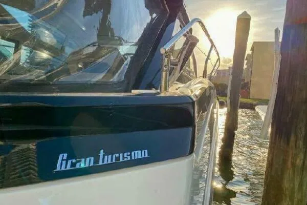 Slide: The Image of 2019 Beneteau Gran Turismo 40 yacht docked at sunset, reflecting on water. - 26