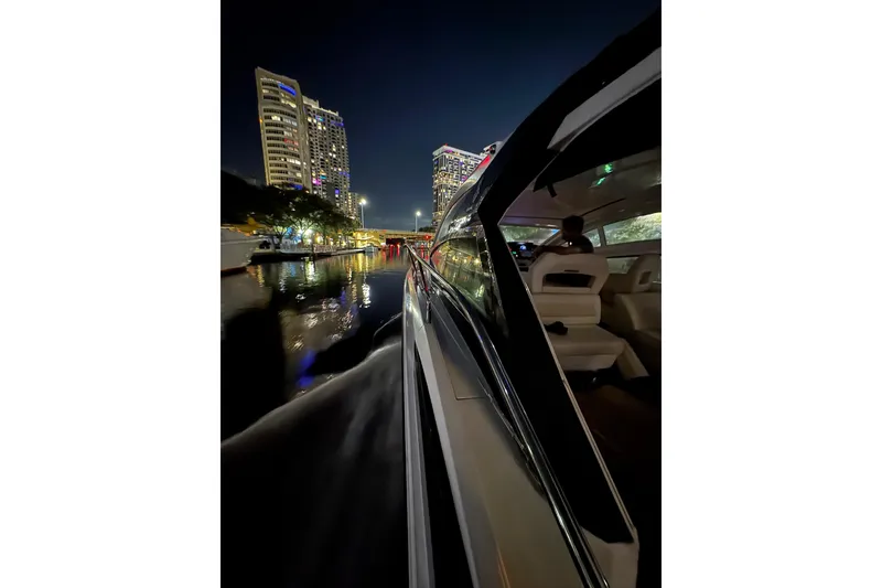 Slide: The Image of 2019 Beneteau Gran Turismo 40 cruising at night near illuminated cityscape. - 28