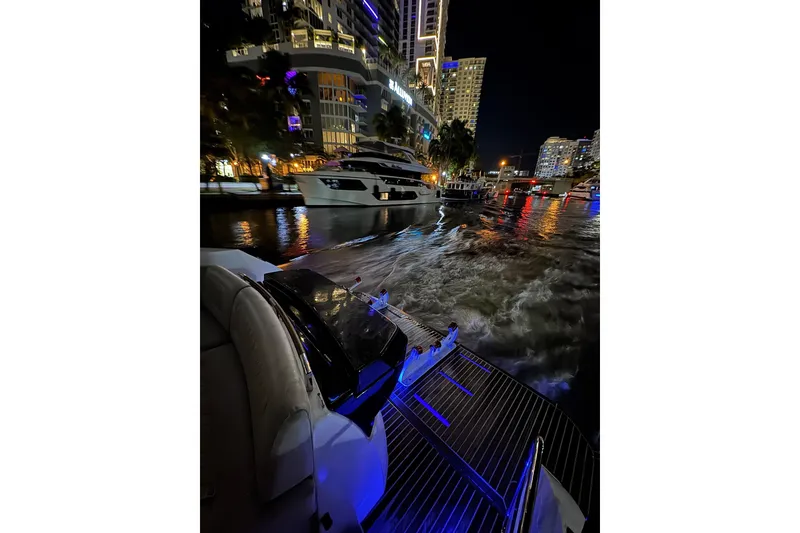 Slide: The Image of 2019 Beneteau Gran Turismo 40 yacht cruising at night in illuminated cityscape. - 29