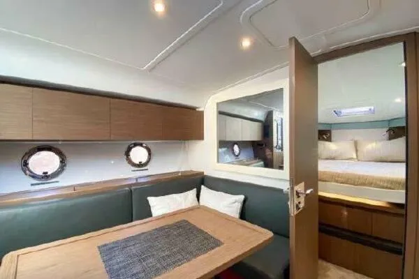 Slide: The Image of Interior of 2019 Beneteau Gran Turismo 40 yacht with dining area and bedroom. - 4