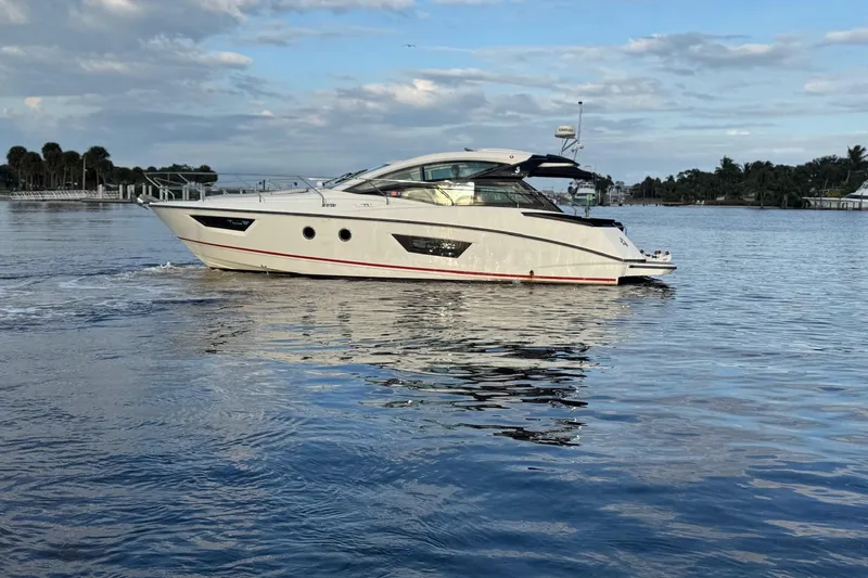 Slide: The Image of 2019 Beneteau Gran Turismo 40 yacht cruising on calm waters under a cloudy sky. - 7