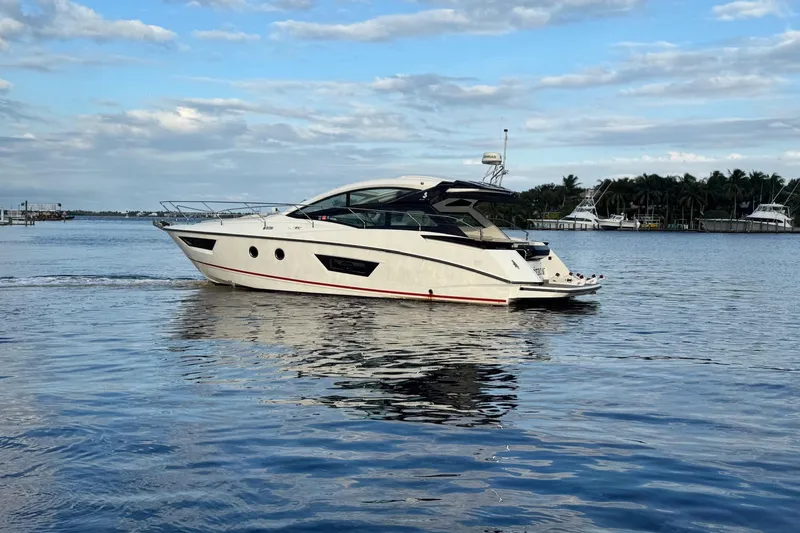 Slide: The Image of 2019 Beneteau Gran Turismo 40 yacht cruising on calm waters under a blue sky. - 8