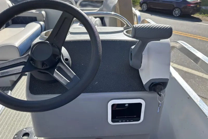 Slide: The Image of Steering console of 2025 Pond-Tini Series 12 (Smoke Rise) boat with key ignition. - 14