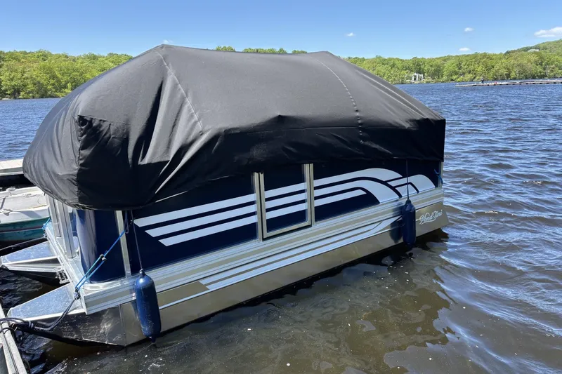 Slide: The Image of 2025 Pond-Tini Series 12 (Smoke Rise) pontoon boat with black cover on a lake. - 18