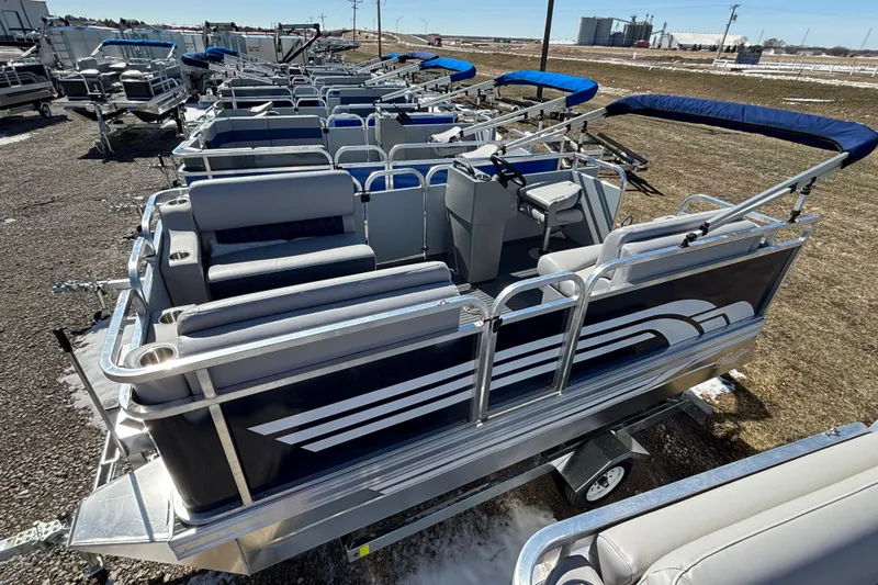 Slide: The Image of 2025 Pond-Tini Series 12 (Smoke Rise) pontoon boat displayed outdoors. - 2