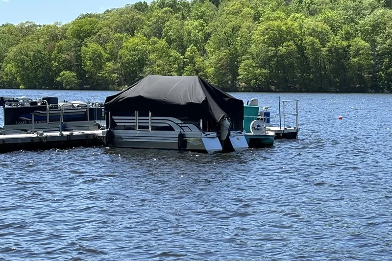 Slide: The Image of Pontoon boat, Pond-Tini Series 12 (Smoke Rise) 2025, docked on a serene lake. - 20