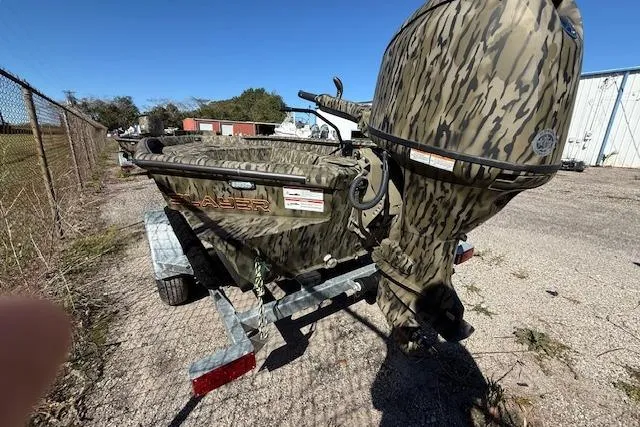 Slide: The Image of 2025 SeaArk 1752 Slayer Pro boat with camouflage design on a trailer. - 5