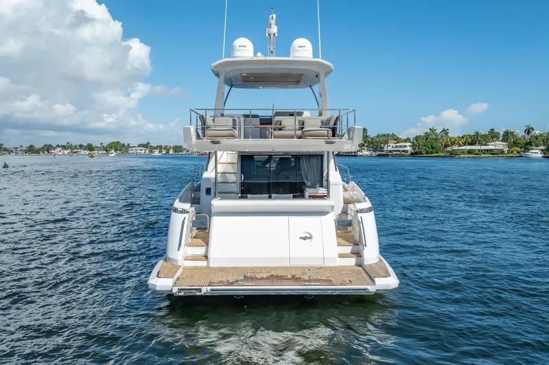 Slide: The Image of 2019 Azimut 66 yacht on calm water, showcasing luxurious design and spacious deck. - 18