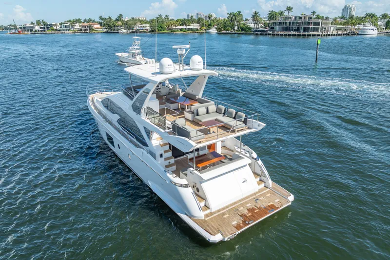 Slide: The Image of Luxurious 2019 Azimut 66 yacht cruising on a sunny day, showcasing elegant design and spacious decks. - 21