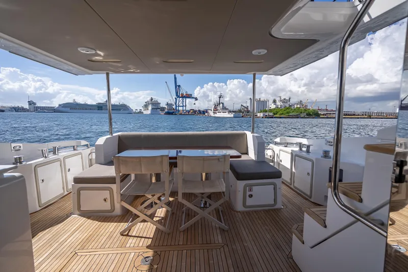 Slide: The Image of Luxurious 2019 Azimut 66 yacht deck with seating, overlooking a bustling harbor. - 29